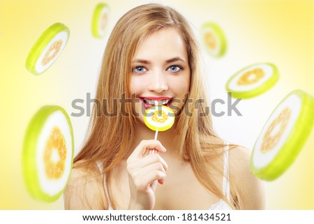 Lollipop. Girl with lollipop on a yellow background