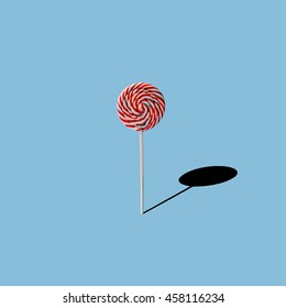 Lollipop on blue background. Minimal concept