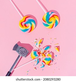 Lollipops On Pastel Pink Background, Top View. Broken With Hammer Candy. Sugar Detox And Junk Food Concept.