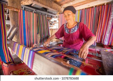 LOMBOK, INDONESIA : 4 JUNE 2015 - Sasak old woman traditionally makes yarn with a spindle wheel at traditional Sasak village, Desa Sasak Sade, Lombok Indonesia.