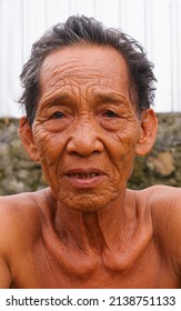 LOMBOK, INDONESIA-MARET 24,2022:Asian Old Man Facial Expression Photo With Faint Smile