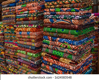 Lome, Togo - 29/12/2019. Stack of colorful african fabrics called Kente.