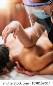 Lomilomi Practitioner Wearing A Protective Mask, Giving Back Massage With An Elbow At A Wellness Center