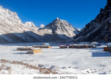 The Lonak tea house with the snow-covered mountain in the background. This beautiful image captured during the Kanchenjunga base camp trek in Nepal. - Powered by Shutterstock