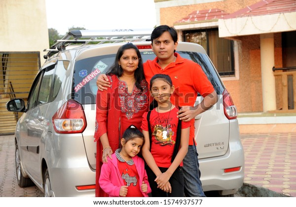 Lonavala, Maharashtra, India, Asia Nov.\
2015 - Indian Happy Family with Newly Purchased\
Car
