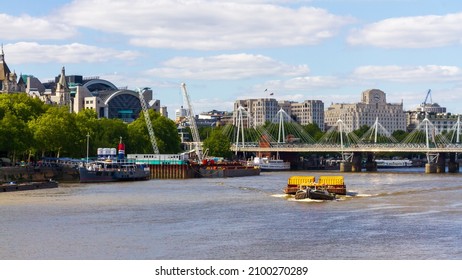 London, 14th May 2020: A Tug Boat Pulling Fright On The Thames In London In Front Of Hungerford Bridge