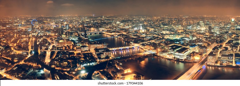 London aerial view panorama at night with urban architectures and bridges.