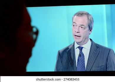 LONDON - APR 4: A Viewer Watches UKIP Leader Nigel Farage On An Election TV Debate On Apr 4, 2015 In London, UK. Major Political Parties Joined The Live TV Debate Ahead Of Polls On May 7.