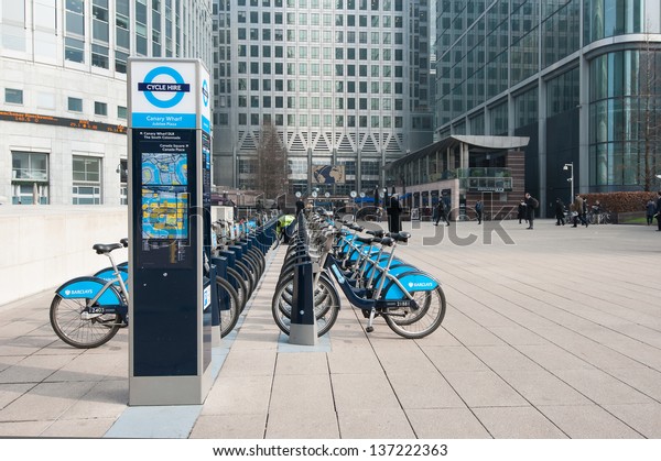 LONDON - APRIL 10: Barclays Cycle Hire in Canary\
Wharf on April 10, 2013. Barclays Cycle Hire (BCH) is a public\
bicycle sharing scheme in London, currently with 8,000 cycles and\
570 docking station.