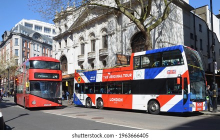 LONDON - APRIL 17, 2021. A Large London Site Seeing Tourist Bus Together With A Standard Bus In Charing Cross Road, Central London, UK.