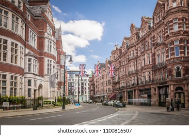 LONDON- APRIL, 2018: Carlos Place in Mayfair on the corner of Mount Street, an upmarket shopping street with red brick buildings