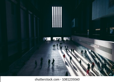 LONDON - APRIL 26, 2018: People Walking In Interior Of Tate Modern Turbine Hall In London