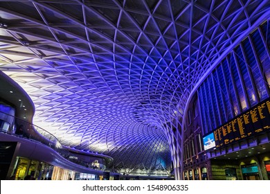 LONDON - AUGUST 10, 2019: Commuters Walking Under The Modern Ceiling Inside The Departure Concourse Of Kings Cross Station In Central London.