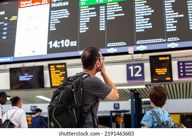 LONDON - August 17 2022: Man Looking At Departure Board In Victoria Station