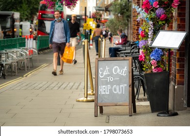 London- August, 2020: Eat Out To Help Out Sign On London High Street- UK Government Scheme To Help Restaurants Through The Covid 19 Downturn