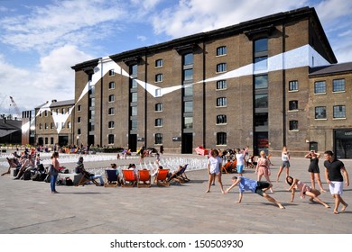 LONDON - AUGUST 4. Dancers rehearsing in Granary Square, a regeneration development with 1000 small fountains and graphics coordinating the historic buildings, on August 4, 2013, in London, UK.