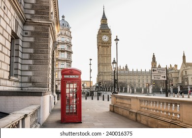 London - Big Ben tower and a red phone booth . Telephone box empty streets. Covid 19 Coronavirus lockdown