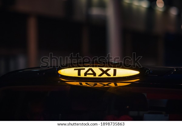 London black cab taxi sign
at night