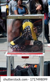 LONDON, BRITAIN - APRIL 28, 2016: Contortionist Fits Entire Body Into Glass Box.