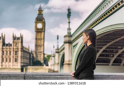 London Business People City Lifestyle Young Businesswoman Looking At Parliament Big Ben Clock Tower, UK. Europe Politics Solicitor Or Realtor, Woman Wearing Formal Black Suit For Career Life.