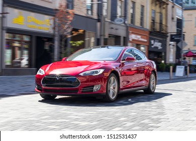 LONDON, CANADA - September 19, 2019: Tesla Model S driving through an urban city centre. 