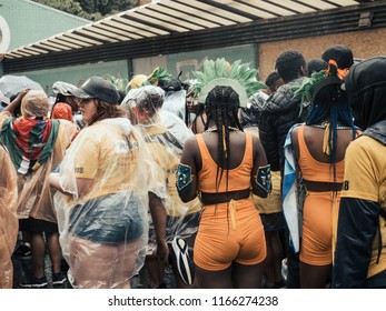 London, London City / United Kingdom - August 26, 2018: Notting Hill Carnival 2018. Carribean People Are​ Dancing In The Rain. Second Largest Carnival In The World.