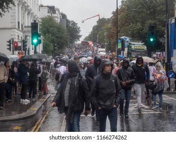 London, London City / United Kingdom - August 26, 2018: Notting Hill Carnival 2018. Carribean People Are​ Dancing In The Rain. Second Largest Carnival In The World.