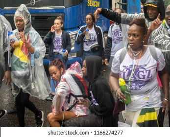 London, London City / United Kingdom - August 26, 2018: Notting Hill Carnival 2018. Carribean People Are​ Dancing In The Rain. Second Largest Carnival In The World.