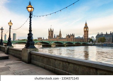 London cityscape with Dolphin lamp posts on the Queens Walk promenade between Lambeth Bridge and Tower Bridge in foreground and the Parliament, the Big Ben and the Westminster Bridge in background