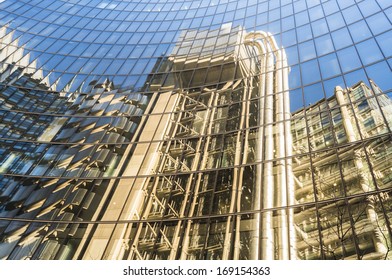 LONDON - DEC 28: Reflection Of Lloyds Building On Dec 28, 2013, In London, UK. Originally Built In 1928 (design By R. Rogers), Demolished, Reconstructed And Opened By Queen Elizabeth II In 1986. 