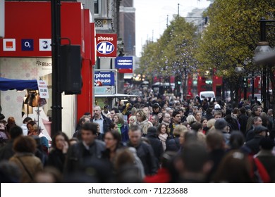 LONDON - DECEMBER 11: The Famous Oxford Street Pack With Crowds Of Tourists And Locals Doing Their Last Minute Christmas Shopping December 11, 2010 In London, United Kingdom.