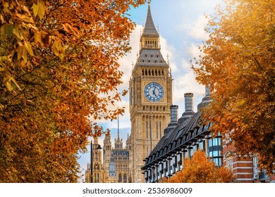 London during autumn time with the Big Ben clocktower at Westminsterin and colourful foliage - Powered by Shutterstock