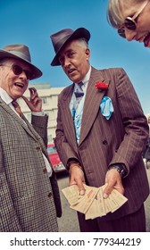 London, England, 05/05/2017, A Main In 1920s Fancy Dress As A Mobster Mafia Con Artists Seller Of Fake And Stolen Goods On His Wrist. Handsome And Untrustworthy Street Trader. 