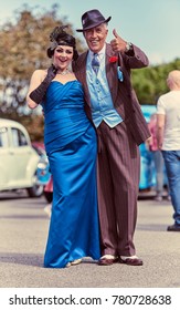 London, England, 05/05/2017, A Main In 1920s Fancy Dress As A Mobster Mafia Con Artist, With A Gatsby Girl. Handsome And Untrustworthy Street Trader. Fashionable Pin Stripe Suit.