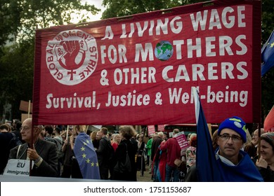 London, England - 08/27/19 - A Group Of Protestors Holding Up A Red Banner About Living Wage And An EU Flag