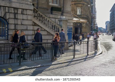 London, England; 08,28,2015: People Walking And Talking On The Phone At The Intersection Of Poultry And Mansion House Street