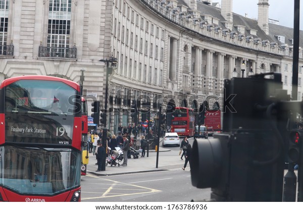 London/ London/ England - 09/09/2019: Walking on\
the streets of London. Bus, buses, traffic, people  and urban\
architecture. coach, skyline, british, pedestrians, transport,\
public, red, double\
decker