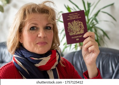 London, England - 12 June 2020: Woman Holding British Passport Wearing Union Jack Scarf 