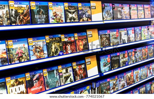 LONDON, ENGLAND 16TH NOVEMBER 2017 - Rows of PS4\
video games for consoles on display inside a local Game Store shop\
in Essex England
