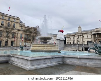 London, England; 18 February 2021 - Water Fountain In Trafalgar Square, The Fourth Plinth Behind.