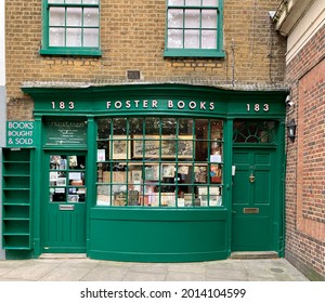 LONDON, ENGLAND - 24.07.2021. Chiswick High Road street view. Famous Foster Books shop decorated with dark green framed shop window. Brick wall, cobblestone. Front view