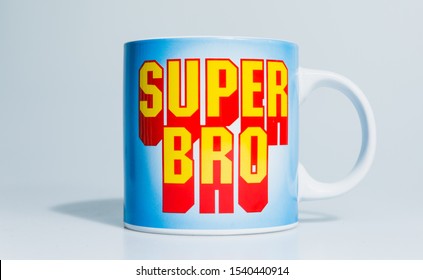 London, England, 24/10/2019 Super Bro Mega Mug On Isolated White Background Lit Professional In Studio. Type In Text Font Like Mario Or Other Retro Games Even Superman Comic Book Style 