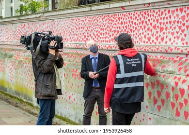 LONDON, ENGLAND- 31 March 2021: Volunteer Being Interviewed At The Covid Memorial Wall