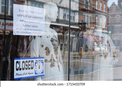 London, England - April 10 2020 - Signs In A Clothing Shop Window In Tooting, Advising That The Store Will Be Closed Until Further Notice During The Covid19 Pandemic Of 2020.