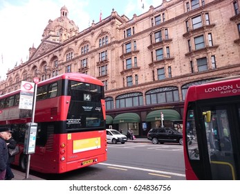 London, England - April 13, 2017: View Of The Main Facade Of The Famous Harrods Store With A Red Bus In Front