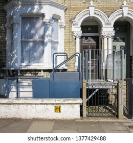 London, England - April 20 2019 - A house in Balham, London, England with an adaptive wheelchair lift outside a house.  This can allow disabled people and wheelchair users access to the house.