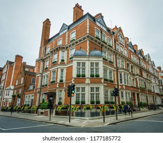 LONDON, ENGLAND - AUGUST 18, 2018: The stunning historic Victorian red brick historic buildings in the upscale Mayfair is among  some of the most expensive real estate in the city.