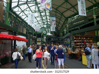 London, England - August 20, 2015: Visitors and shoppers in the covered section of Borough Market in London, England. The market has traded in Southwark, London for more than 250 years