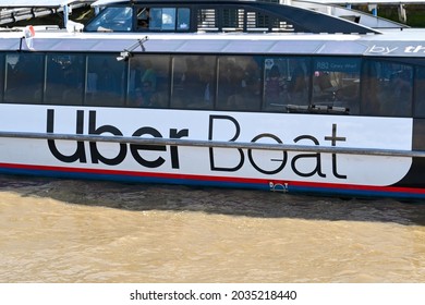 London, England - August 2021: Side View Of A Thames Clipper Water Taxi On The River Thames. The Ferry Is Sponsored By Uber.