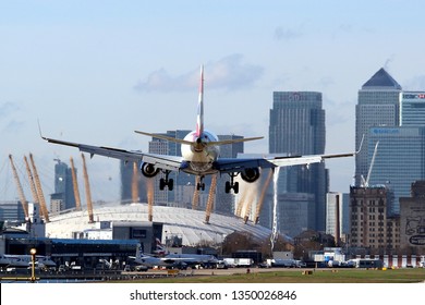 LONDON -ENGLAND CIRCA 2016: London's City Airport With A British Airways Plane Landing. Canary Wharf Is In The Background.